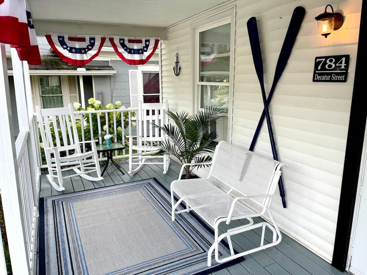 Cozy front porch with rocking chairs and a glider to enjoy your coffee in the morning.