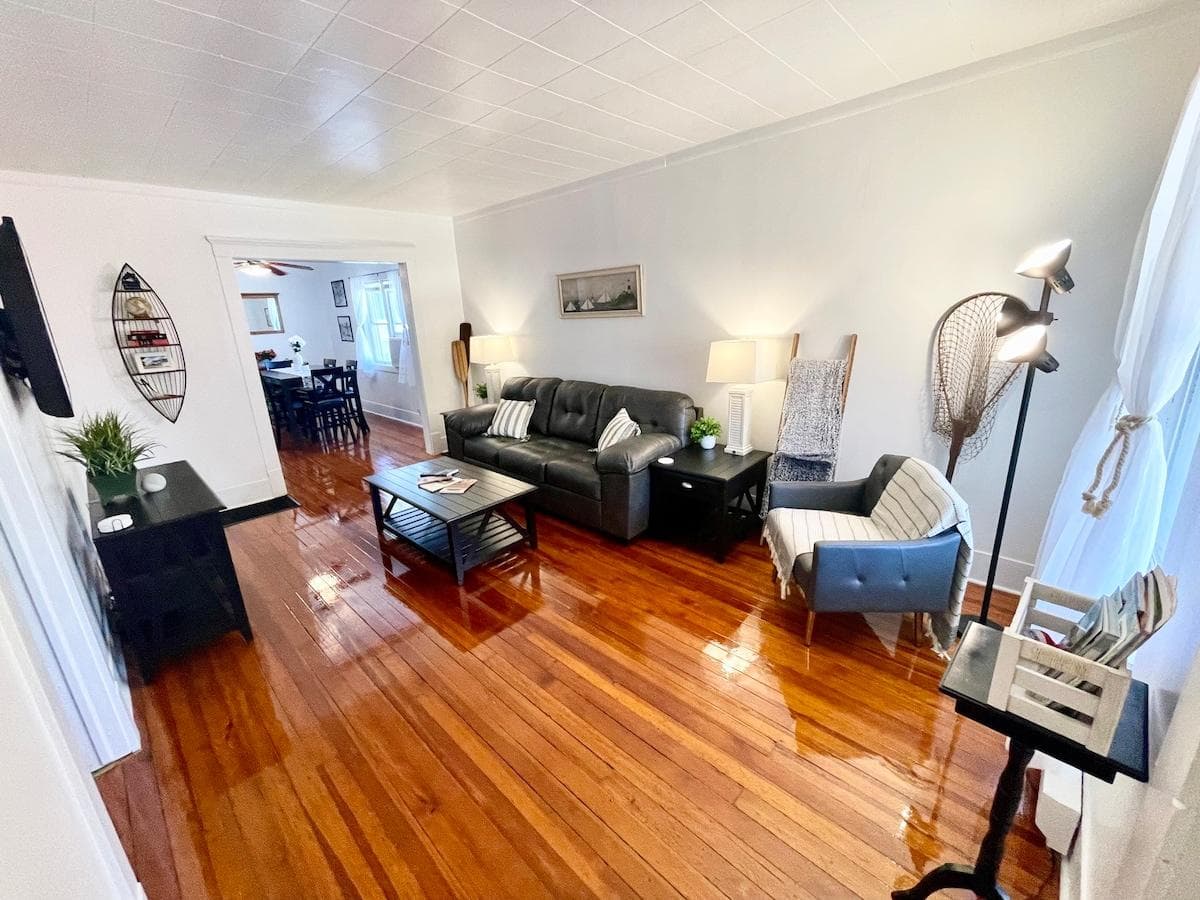 Beautiful, modern living room featuring restored original hardwood flooring of this 1920s home. 